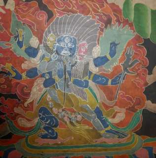 This old tibetan Thangka painting shows a wrathful deity with consort.
